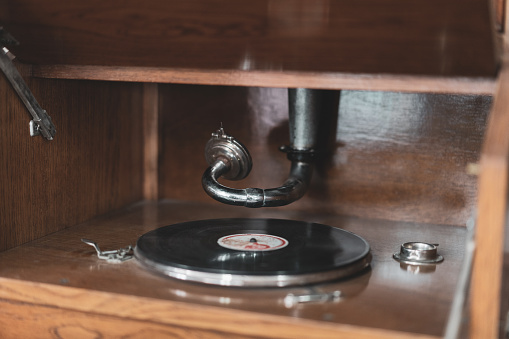 Old vintage wooden vinyl player with needle