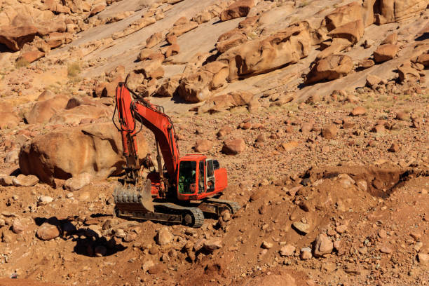 istock Orange excavator working at construction site in desert in Sinai peninsula, Egypt 1413484013
