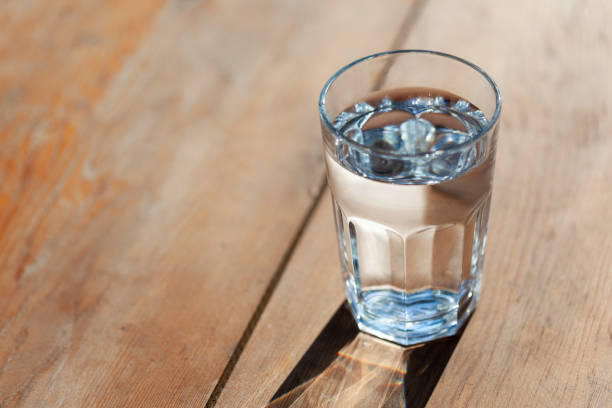 istock glass of water on brown background 1413486540