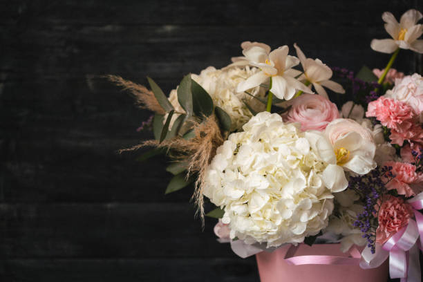 istock Beautiful flowers composition on wooden background 1413489140