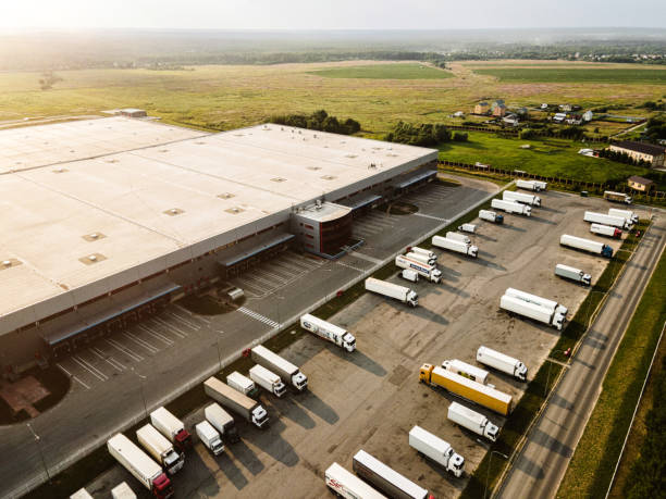 istock Distribution warehouse with trucks at sunset. Aerial view 1413489884