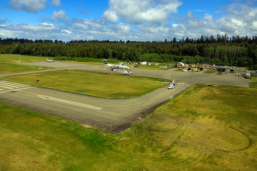 Masset, British Columbia, Canada - June 3, 2022: An aerial view of the runway tarmac of the remote Masset airport located in Haida Gwaii, British Columbia, Canada.