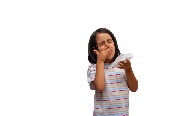 Little girl with cold and flu scratching her nose
