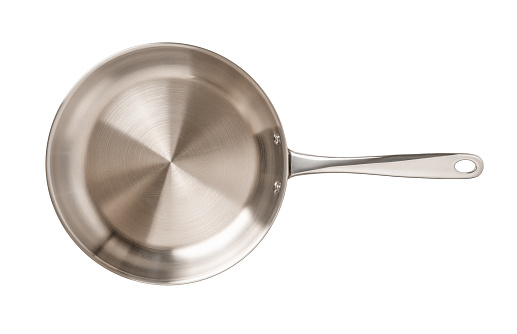 Empty stainless steel skillet isolated on a white background. New frying pan of 18/10 chrome nickel steel cutout. Modern inox cookware. Metal frypan for food frying, searing, and browning. Top view.