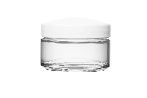transparent gel cream for moisturizing the face in transparent glass jar and white plastic lid on white isolated background.