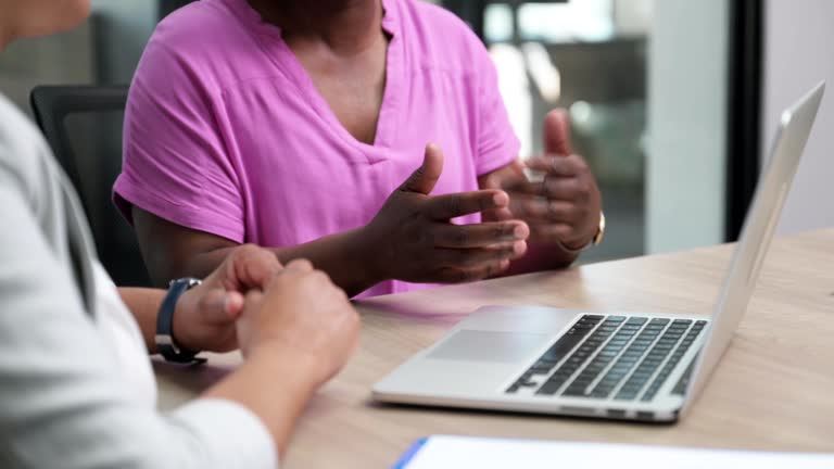 Close up woman points at laptop gesturing with hands while talking in meeting