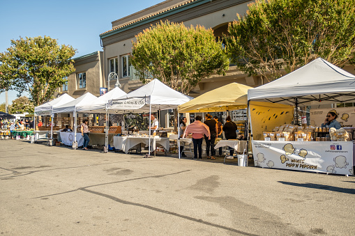 Hollister, CA - July 13, 2022: Various vendors at the Farmer's Market held Wednesday evenings in downtown Hollister.