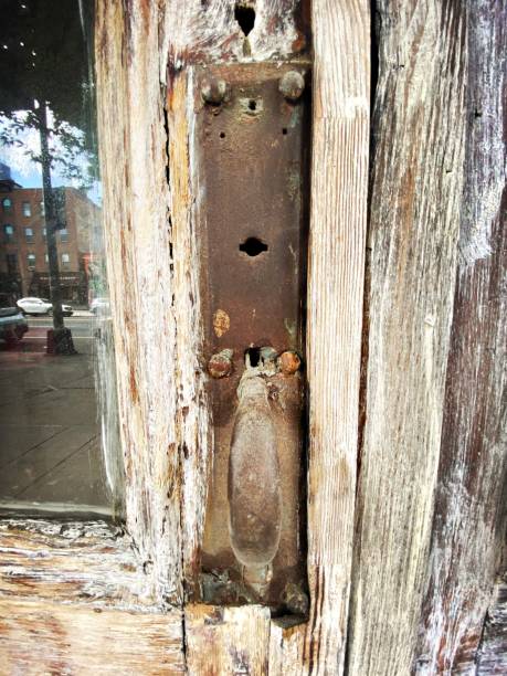 istock Old Fashioned Door Handle on a weathered door 1413498148
