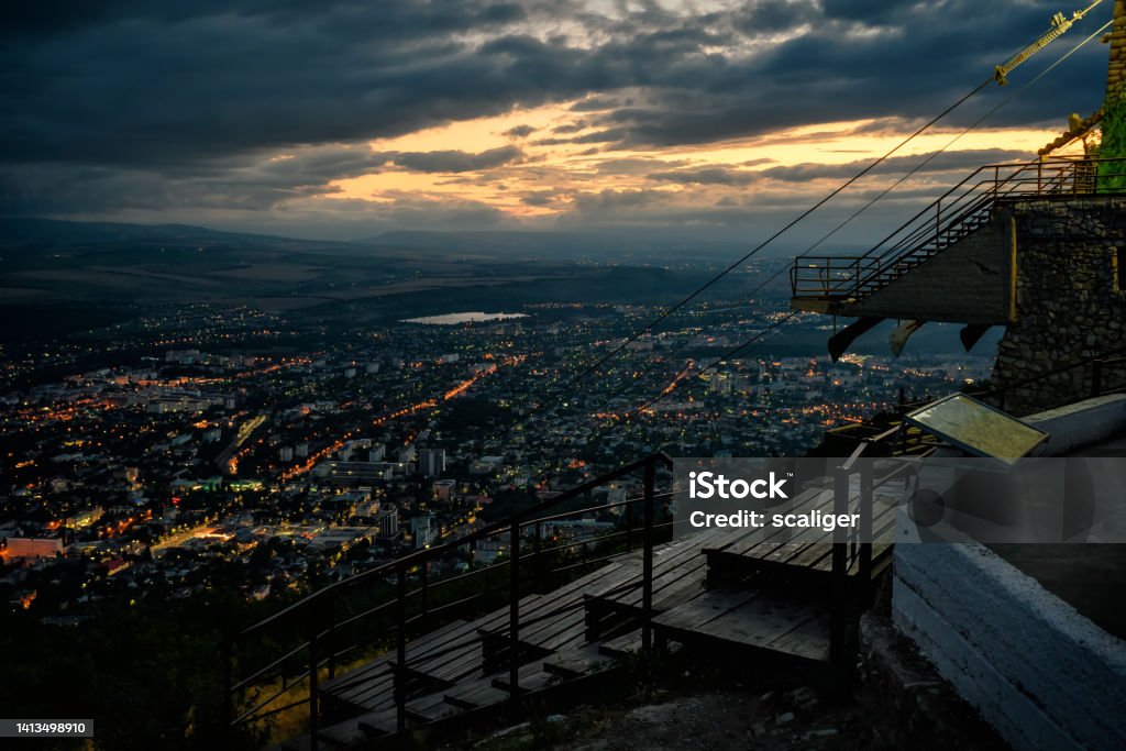 Cable car station on Mashuk Mountain at night, Pyatigorsk, Russia Cable car station on Mashuk Mountain at night, Pyatigorsk, Russia. Nice skyline, landscape of Pyatigorsk with sunset sky. Pyatigorsk city funicular view at dusk. Tourism and travel in Stavropol Krai. Aerial View Stock Photo