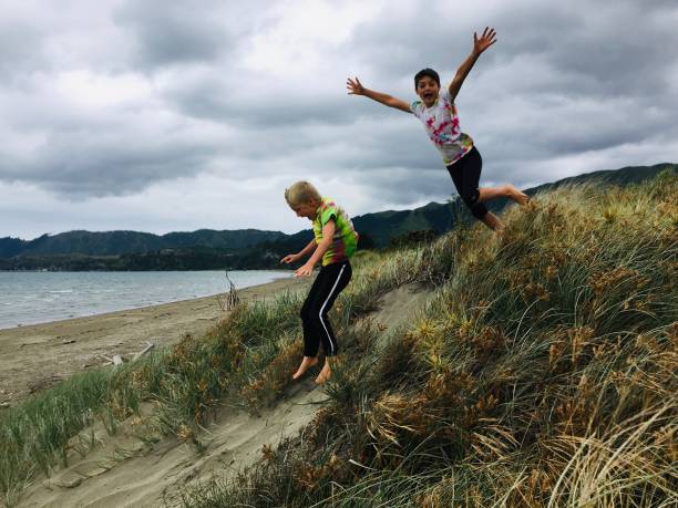 istock Children Jumping at the Beach 1413500754