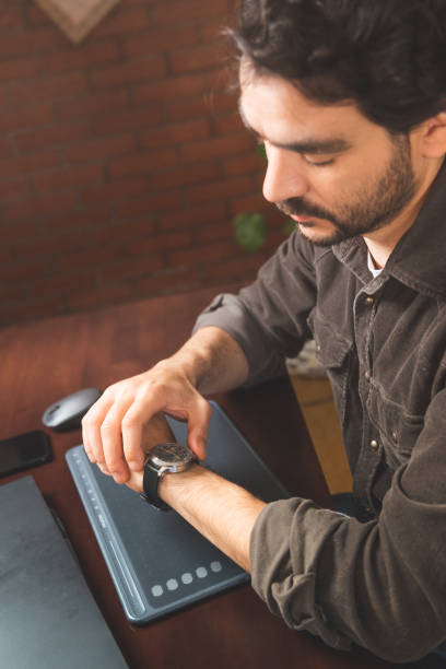 istock bearded man working with laptop computer at home, assisted design project 1413501725