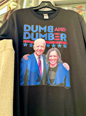 Deadwood, South Dakota, USA - July 7, 2022: A political t-shirt for sale hangs outside a gift shop on Historic Main Street in downtown Deadwood.