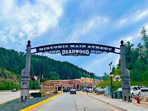 Deadwood, South Dakota, USA - July 7, 2022: Visitors to historic Deadwood in the Black Hills region are welcomed to town with a large sign at the entrance to “Historic Main Street”.
