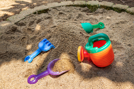 Plastic tools for playing with sand in the park