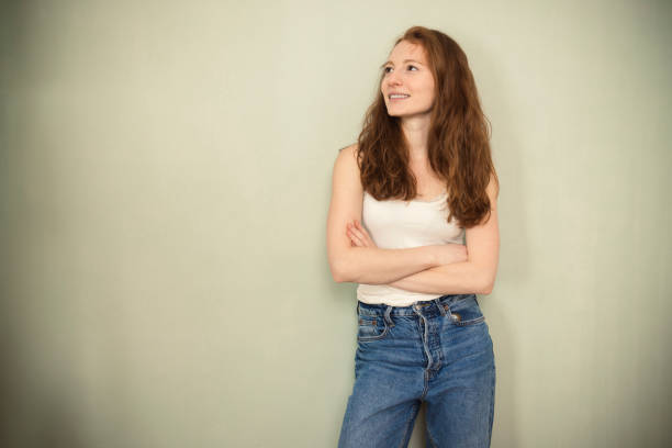 istock Pretty young woman grinning at the camera 1413505891