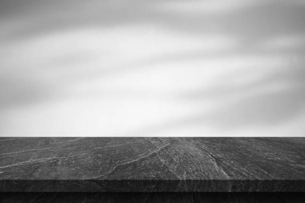 istock Marble table with tree shadow drop on white wall background for mockup product display 1413506135