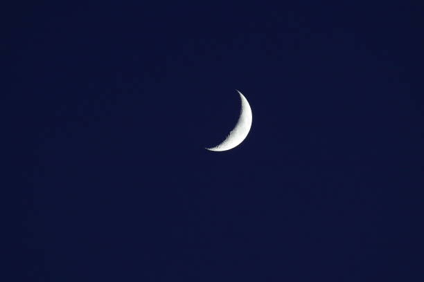 istock new moon or crescent moon up close in a dark blue night sky 1413511940