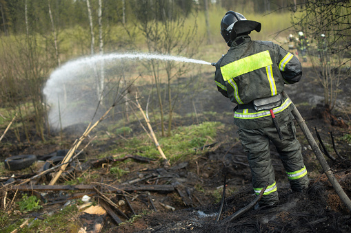 Yakutsk, Russia - August 3, 2021: The firefighter shows his hand the direction of movement to the fire. Forest fires.