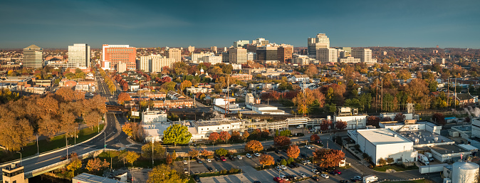 Panoramic drone shot of Wilmington, Delaware on a Fall morning from over the Christina River, looking across streets of row houses towards downtown office buildings. 

Authorization was obtained from the FAA for this operation in restricted airspace.