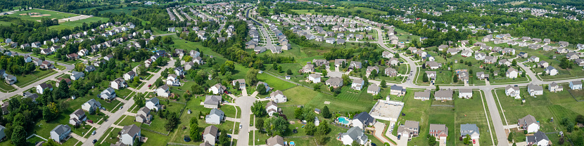 Panoramic drone shot of suburban development on the edge of Monroe, Ohio on a sunny day in summer.
