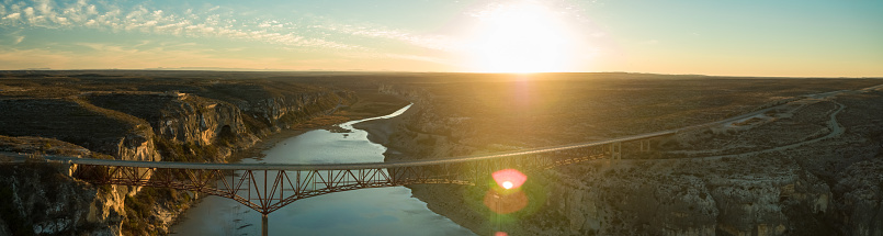 Panoramic drone shot of the Pecos River Highway Bridge, which carries U.S. Highway 90 across the Pecos River Canyon.
