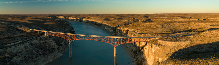 Panoramic drone shot of the Pecos River Highway Bridge, which carries U.S. Highway 90 across the Pecos River Canyon.