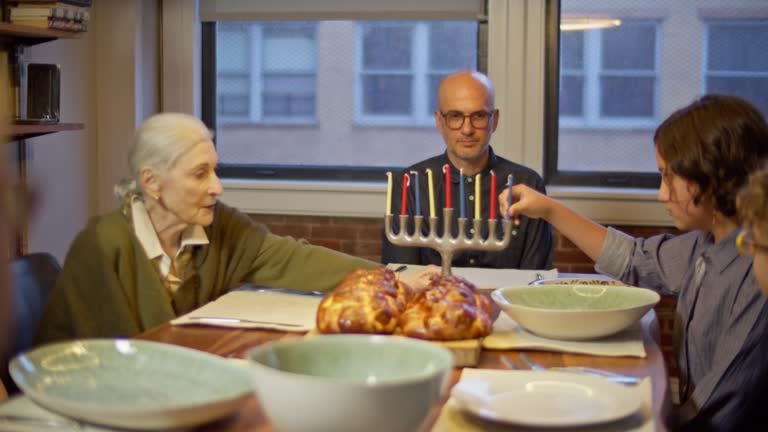 Grandmother Helping Put Candles In the Hanukiah