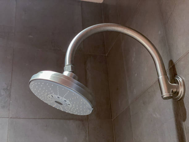 istock Modern round shower head in tiled shower 1413518698