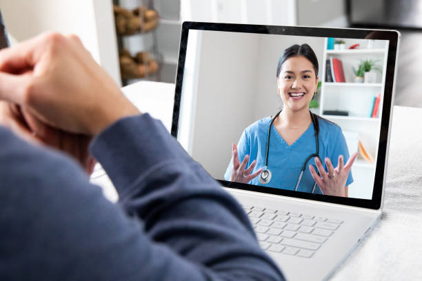 Patient at home while on video conference call with Doctor Patient at home while on video conference call with Doctor telemedicine stock pictures, royalty-free photos & images