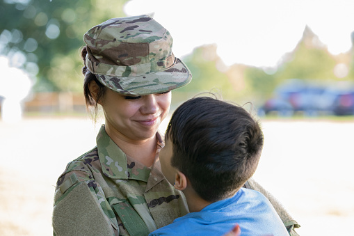 Military Personnel embracing family member