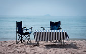 Desk and chair setting on beach on summer holiday.