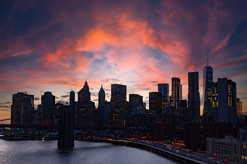 Colorful clouds above the buildings of the New York City skyline at dusk