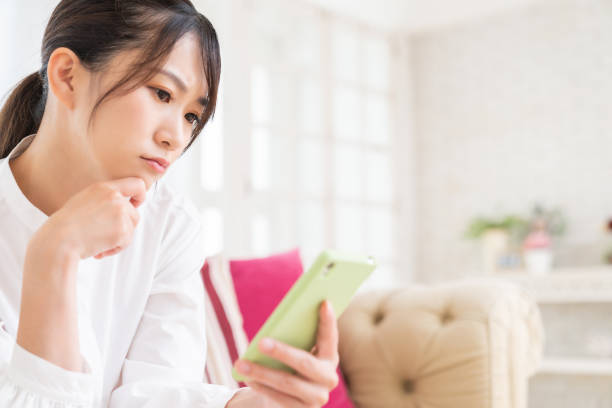 istock attractive Asian woman using a smart phone,think, 1413520156