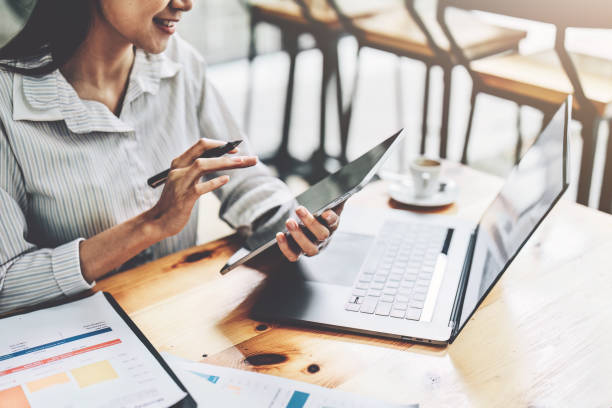 istock Portrait of an Asian female employee using a tablet computer at work. 1413524177