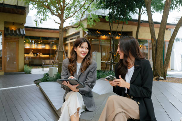 istock Two Businesswomen work outside in a comfortable park. 1413530259