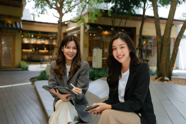 istock Two Businesswomen work outside in a comfortable park. 1413530292