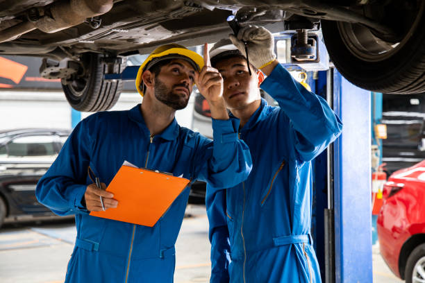 istock Two mechanic was checking the car suspension. 1413530634