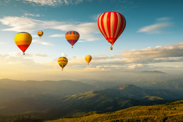 istock hot air balloons flying over mountain 1413530732
