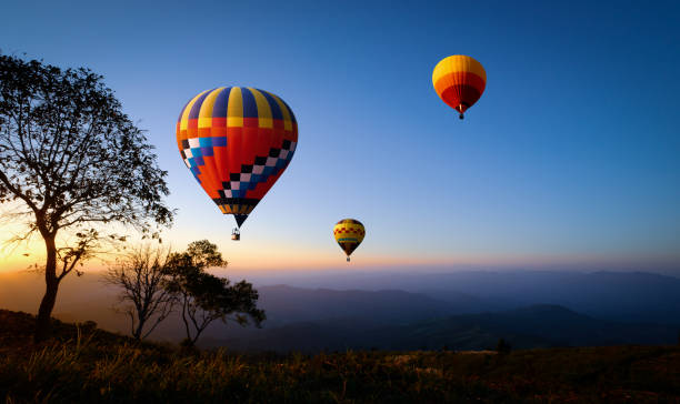istock hot air balloons flying over mountain 1413530749