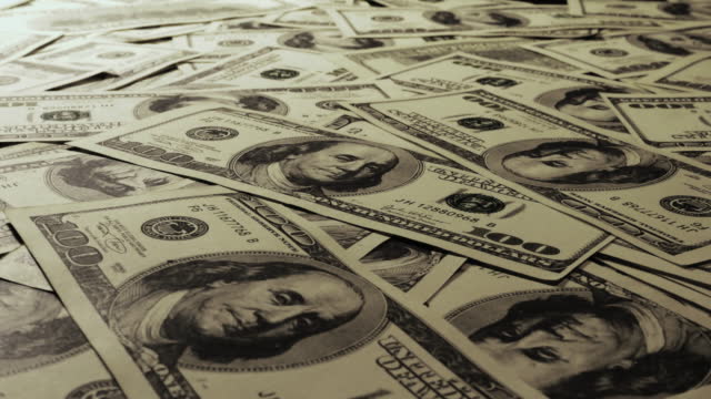 Close-up of a hundred dollar bill on the table, Slider shot