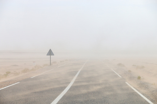 Heavy sandstorm on the road through the Sahara desert