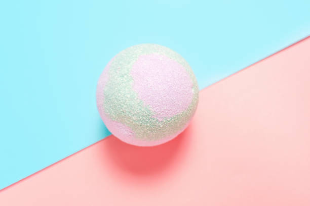istock Colorful bath bomb on pink and blue background top view close-up. 1413536471