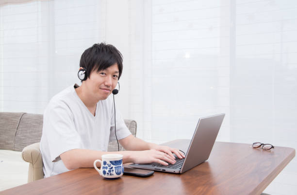istock Japanese young man teleworking 1413537048