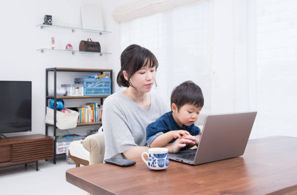 istock Japanese woman working from home while raising children 1413537075