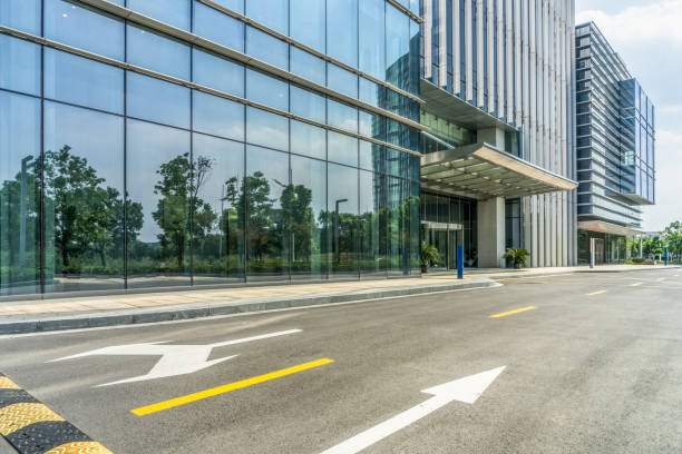 istock empty asphalt road near glass office building 1413538069
