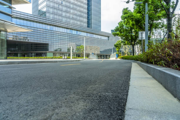 istock empty asphalt road near glass office building 1413538074