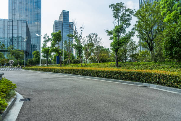 istock empty asphalt road near glass office building 1413538170