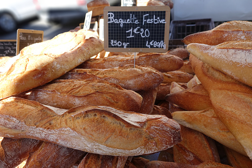 Baguettes of bread on sale  Bakery in an outdoor market  Euro price tag Handwritten lettering  French language