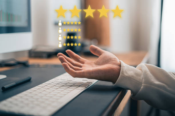 istock Hand and Phone With Five Star Rating 1413540592