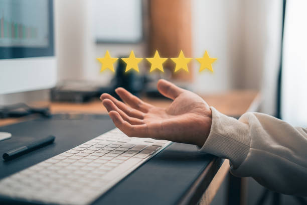 istock Hand and Phone With Five Star Rating 1413540605